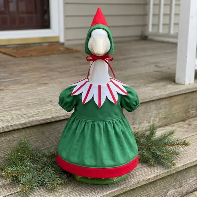 A porch goose wearing the elf outfit