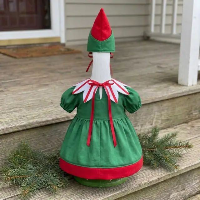 A porch goose wearing the elf outfit, view 2