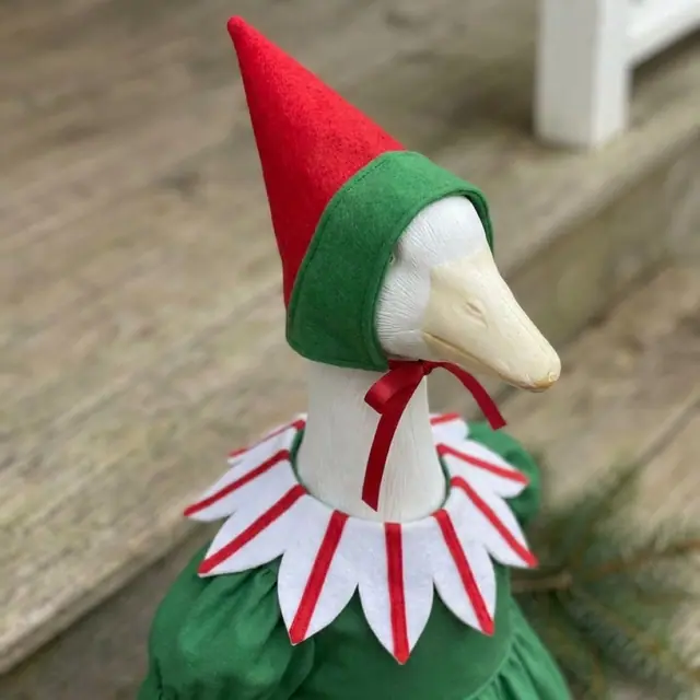 A porch goose wearing the elf outfit, view 3