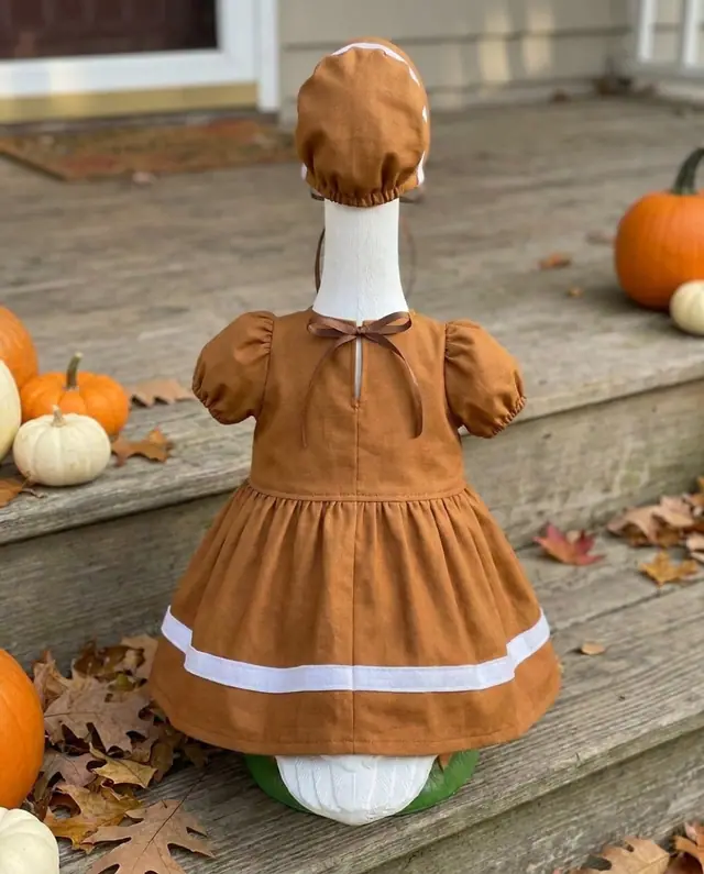 A porch goose wearing the gingerbread outfit, view 2