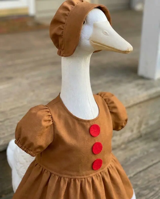 A porch goose wearing the gingerbread outfit, view 3