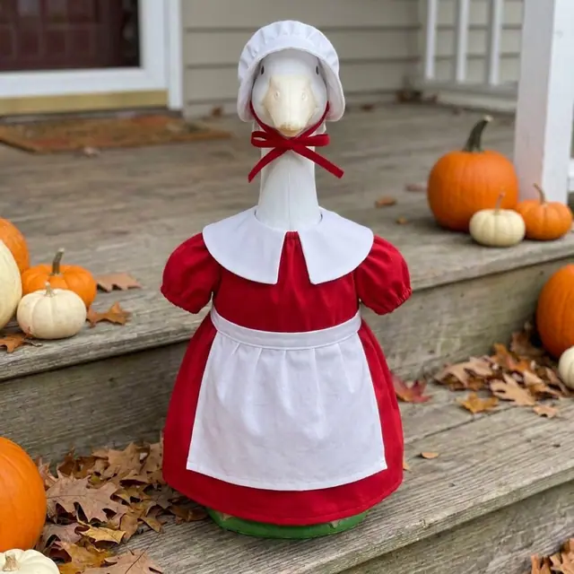 A porch goose wearing the Mrs Claus outfit