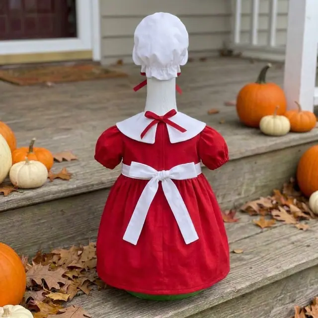 A porch goose wearing the Mrs Claus outfit, view 2