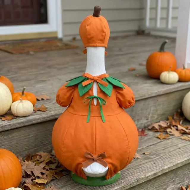 A porch goose wearing the pumpkin outfit, view 2