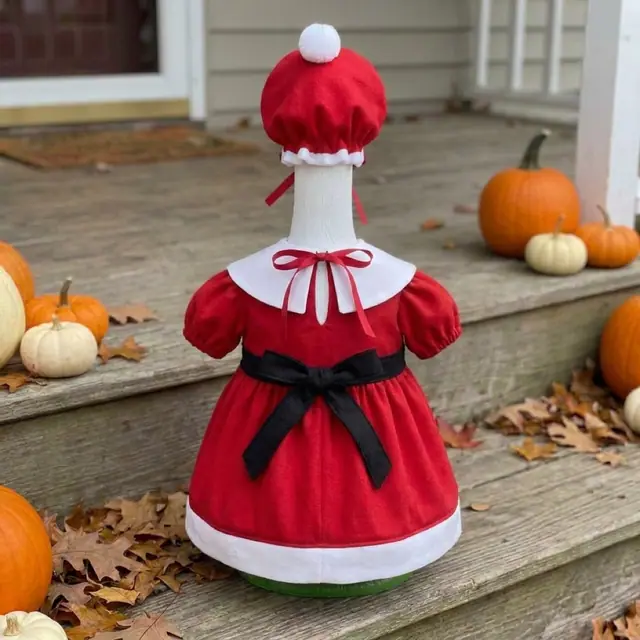 A porch goose wearing the Santa outfit, view 2