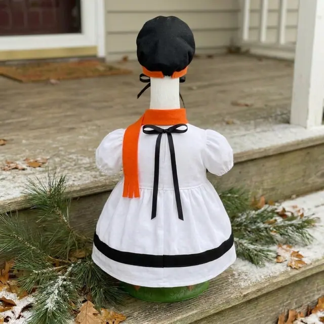 A porch goose wearing the snowman outfit, view 2