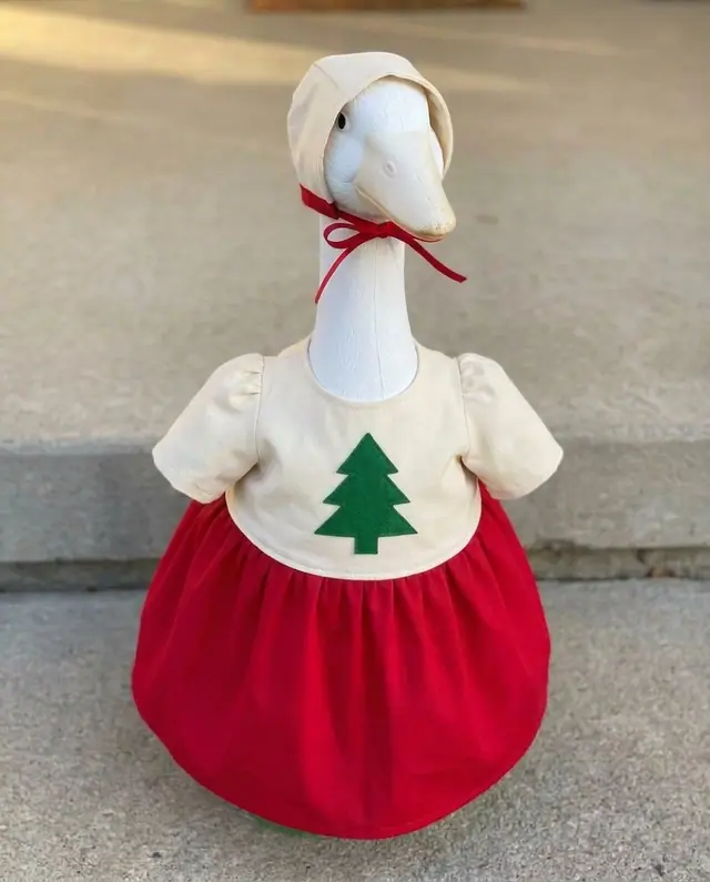 A porch goose wearing the ugly sweater outfit