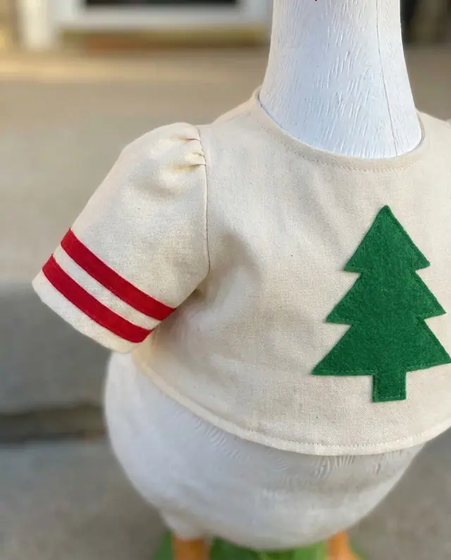 A porch goose wearing the ugly sweater outfit, view 3