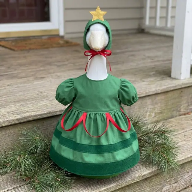 A porch goose wearing the Christmas Tree outfit