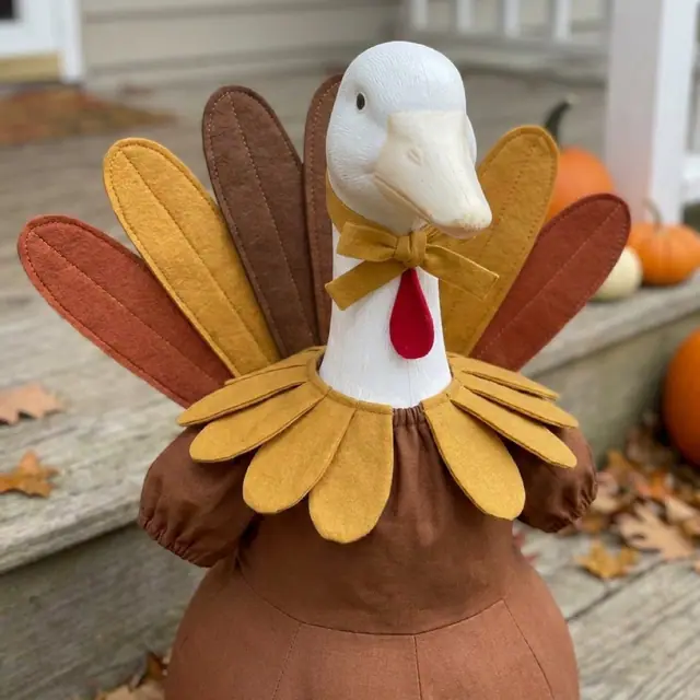 A porch goose wearing the turkey outfit, view 3